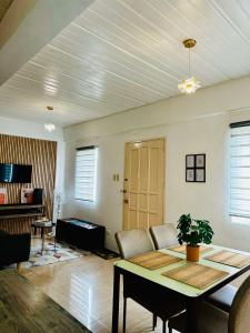 a living room with a table and a couch at Host Homes Camella Whole House- 3BR Cozy Townhouse in Campetic Palo in Palo +16 photos