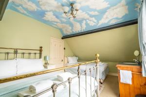 a bedroom with a ceiling with clouds painted on it at Music House in York