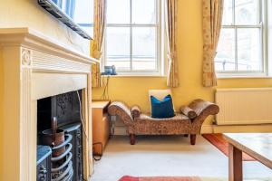 a living room with a chair and a fireplace at Music House in York