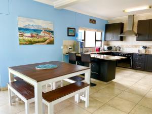 a kitchen with a table and a dining room at Family Beach House Retreat in Swakopmund