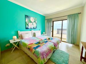 a bedroom with a bed with a view of the ocean at Family Beach House Retreat in Swakopmund