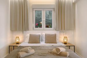 a bedroom with a bed with two towels on it at Madeira Funchal Stay in Funchal