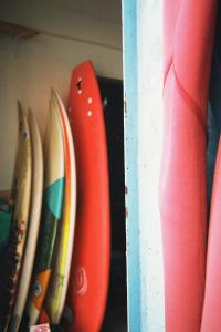 a group of surfboards are on a shelf at Single bed - Cozy dormitory - Surf territory in Agadir