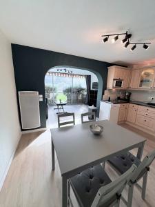 a kitchen with a table and chairs in a room at Appartement T2 avec Piscine 300m plage et crique in Le Pradet