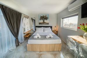 a bedroom with a large bed with two pillows at Paradise Heated Jacuzzi with Acropolis View in Athens +34 photos