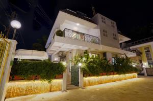 a large white building with plants on it at night at Alaya Stays Adarsh Elegant 3-BHK Villa With Private Pool in Lonavala
