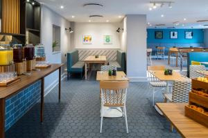 a fast food restaurant with tables and chairs at Holiday Inn London-Bexley by IHG in Bexley