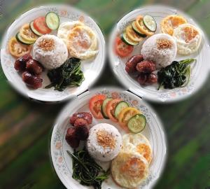 a group of four plates of food on a table at Døng-elays Homestay in Maligcong