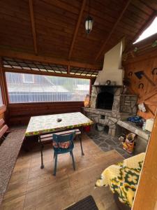 a living room with a table and a fireplace at Penzión Stodola in Ždiar