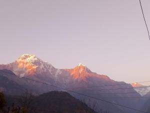 a view of a mountain range with a power line at Ananya homestey in Astam