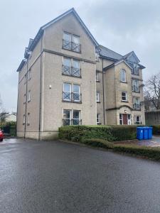 a large brick building with a car parked in front of it at Prime City Centre - Ground Floor Parking By Tba in Dunfermline