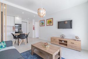 a living room with a couch and a table at Don Tenorio Chic Apartment in Lagos