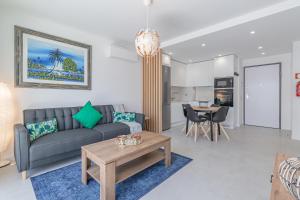 a living room with a couch and a table at Don Tenorio Chic Apartment in Lagos