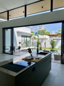 an open kitchen with a view of a pool at Villa Miss Elephant in Ban Thung