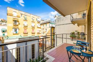 a balcony with a table and chairs on a balcony at Street Stritt'60 by Wonderful Italy in Naples