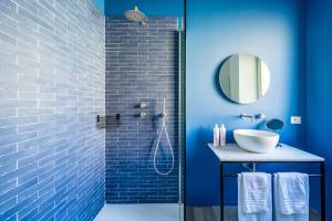 a blue bathroom with a sink and a shower at Street Stritt'60 by Wonderful Italy in Naples +54 photos