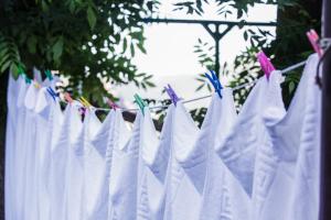 a bunch of white clothes hanging on a clothesline at La Posada de Cucayo in Dobres
