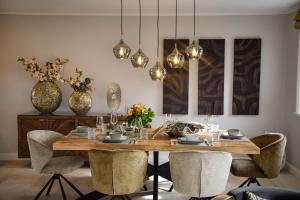 a dining room with a wooden table and chairs at Haus Goed Libben in Archsum +44 photos