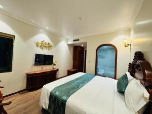 a bedroom with a large bed and a television at Trường Giang Hotel 2 in Móng Cái