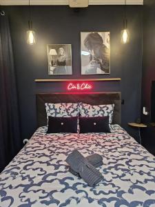 una camera da letto con un letto con un cartello sul muro di Le Cin et Chic Vidéoprojecteur Popcorn Netflix a Saint-Étienne