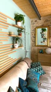 a living room with a couch and a mirror at La Petite Maison d'Emmanuelle in Le Tignet