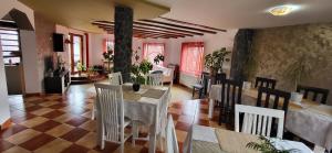 a dining room with tables and chairs in a restaurant at Pension Norbert in Sighişoara