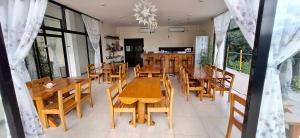 a dining room with wooden tables and chairs at Escape Boutique Hotel in Puerto Princesa City