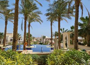 a resort with a pool and palm trees at Luxury Stays in Ancient Sands, El Gouna in Hurghada
