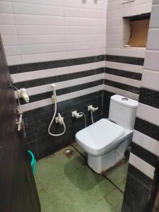 a bathroom with a toilet and a shower at B M little cottage in Mathura