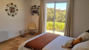 ラ・ロンド・レ・モールにあるLes Romarinsのベッドと大きな窓のある寝室 +32枚の写真