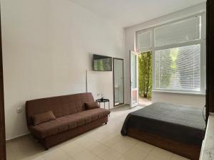 a living room with a couch and a bed at Green Fort Noks - Private apartment - BSR - 3 in Sunny Beach +10 photos