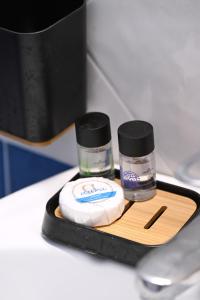 a tray with two bottles of cosmetics on a table at Oneiro Rooms Kythnos in Kanala