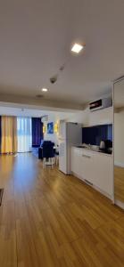 an empty room with a kitchen and a living room at Beachfront Apartaments in Orbi City in Batumi