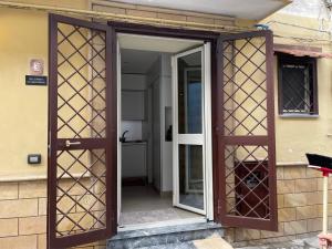 an open door of a house with a glass doorway at Casa Sermoneta in Naples