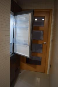 a refrigerator with its door open in a kitchen at Benissanet Tarragona Apartment Cal Sanet in Benissanet