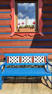a blue bench sitting in front of a window at Penzión Stodola in Ždiar +45 photos