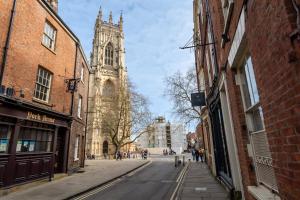 an empty city street with a cathedral in the background at Music House in York