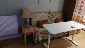 a living room with a table and a couch at Studio apartment in Lichfield City centre in Lichfield