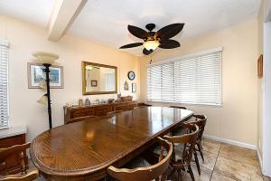 a dining room with a wooden table and a ceiling fan at 315E Lower 315 Eucalyptus Lower in Avalon