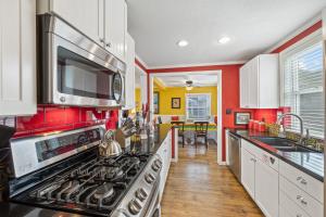 a kitchen with red and yellow walls and a stove at 315E Upper 315 Eucalyptus Upper in Avalon +18 photos