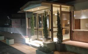 a building with potted plants in front of it at Hotel La Magione in Poggibonsi