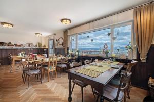 a restaurant with tables and chairs and a large window at Pension Waldliesel in Dornstetten