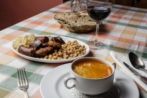 a table with a plate of food and a cup of coffee at La Posada de Cucayo in Dobres