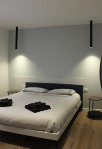 a bedroom with a white bed with two tables at appartamento a iseo in Iseo
