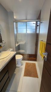 a bathroom with a shower and a toilet and a sink at The Urban Echo in Cochabamba