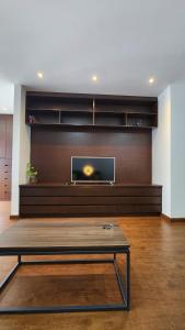 a living room with a flat screen tv on a wall at The Urban Echo in Cochabamba