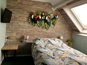 Postel nebo postele na pokoji v ubytování Hotel Dichtbijzee