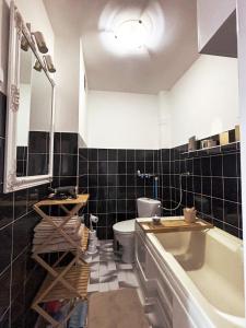 un bagno con vasca, WC e lavandino di Wałcz Homely Apartment a Wałcz