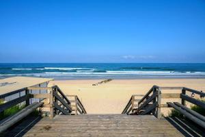 a wooden boardwalk leading to a beach with the ocean at Capcos in Escource