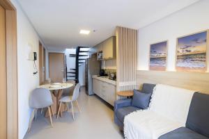 a small living room with a couch and a table at Oceânica Cabo Branco By Carpediem in Tambaú